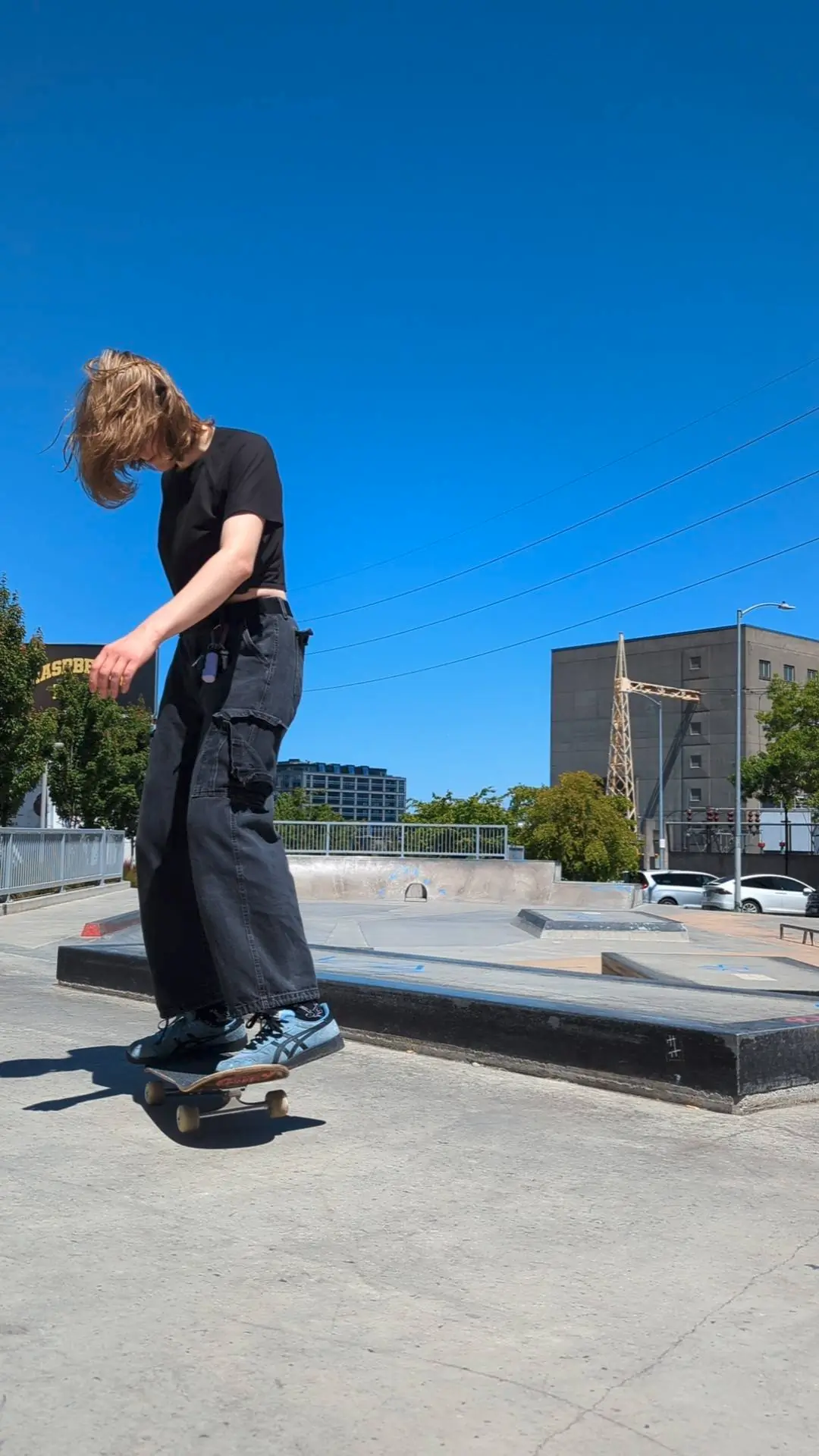 Gen after hitting a 180 50-50 grind, with matcha colored trees in the background